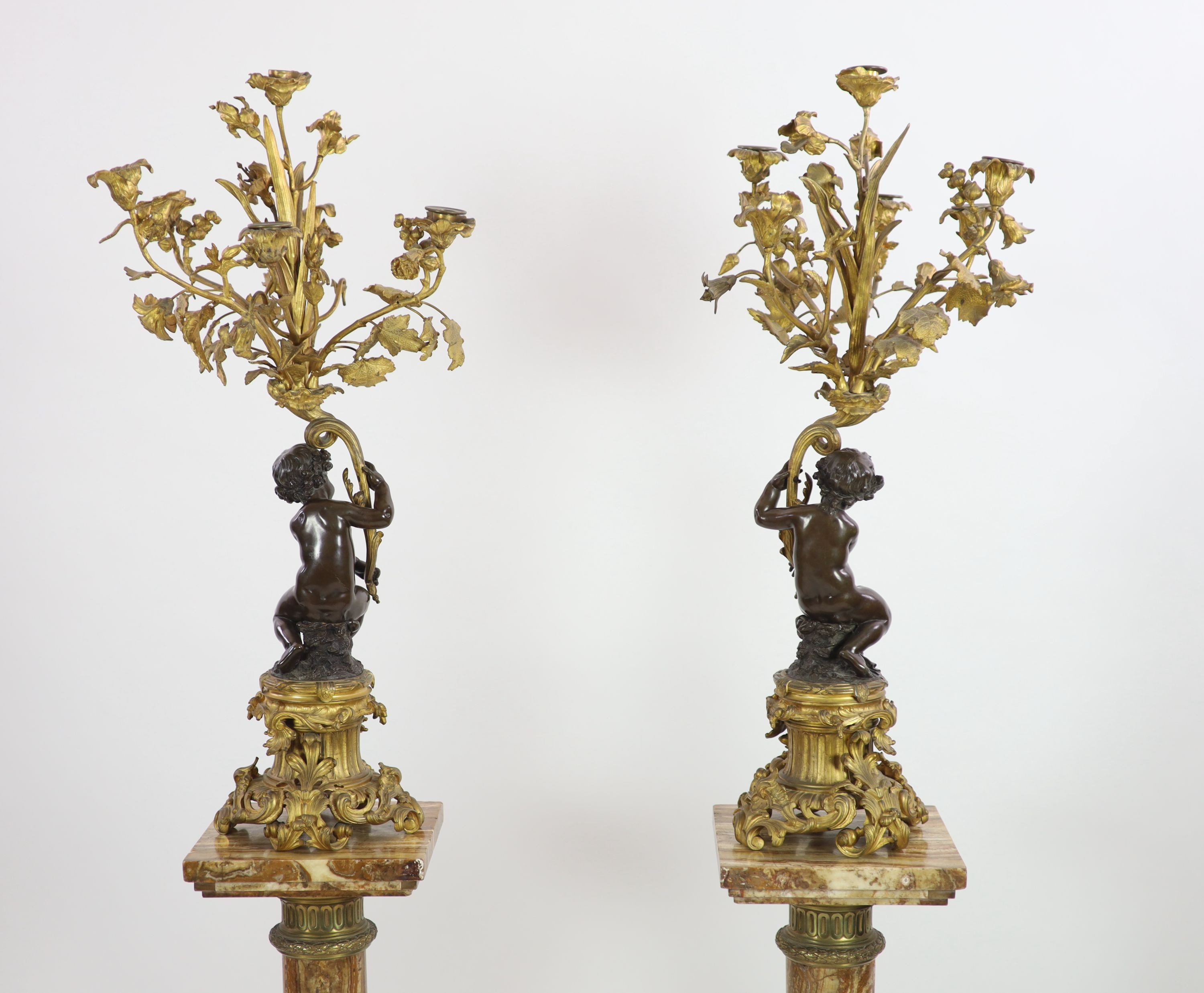 A pair of 19th century French bronze and ormolu six light candelabra, W.27cm H.109cm